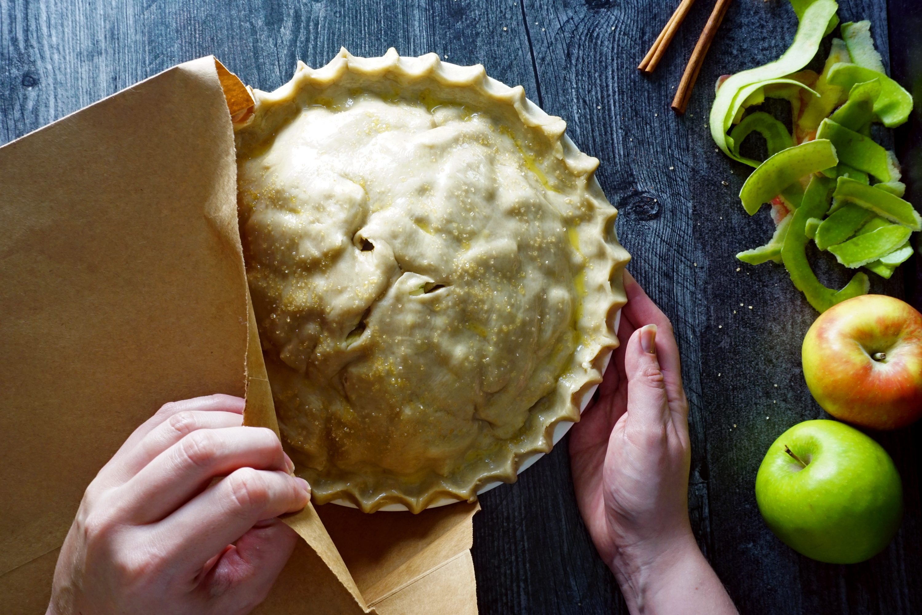 Apple Pie In A Bag placing prepared pie into a plain brown paper bag to bake