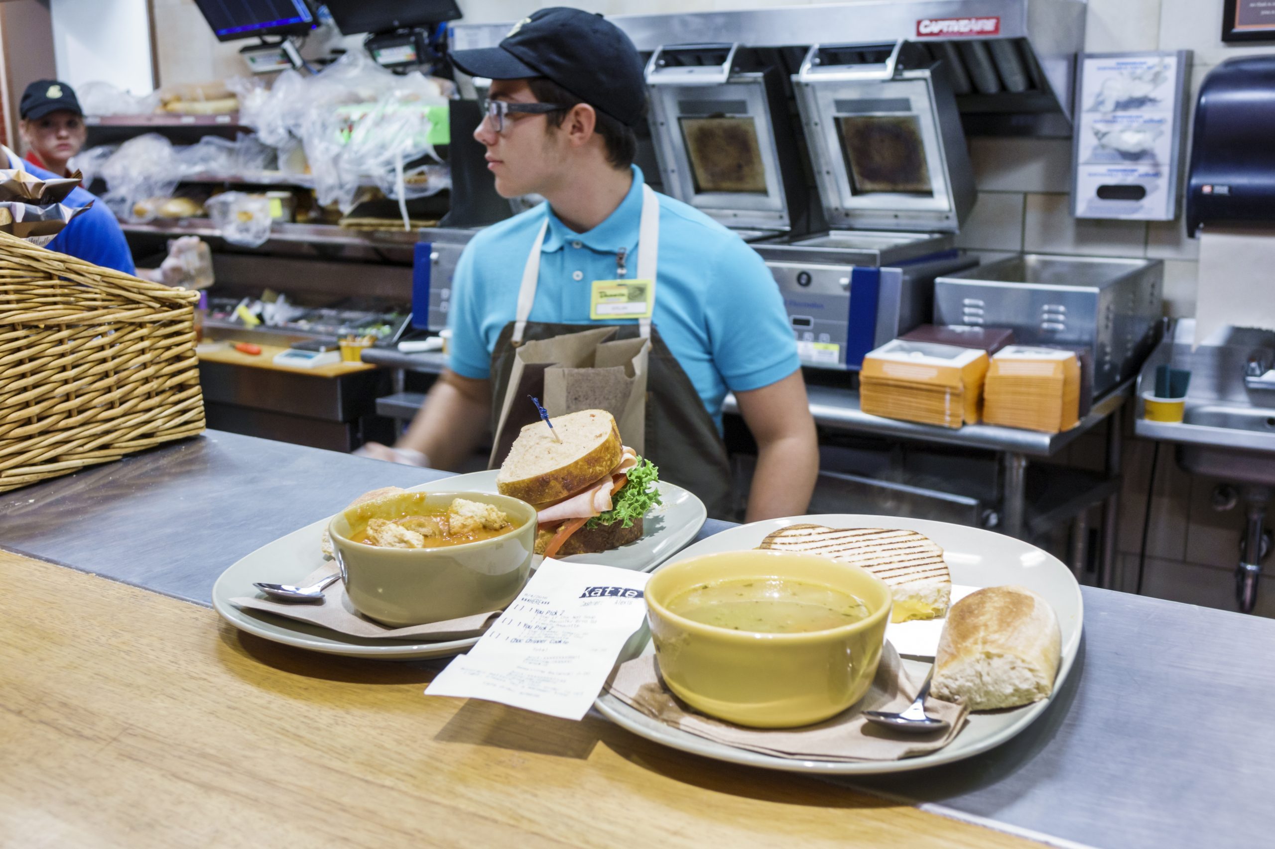 Plates of food on the counter inside Panera Bread.