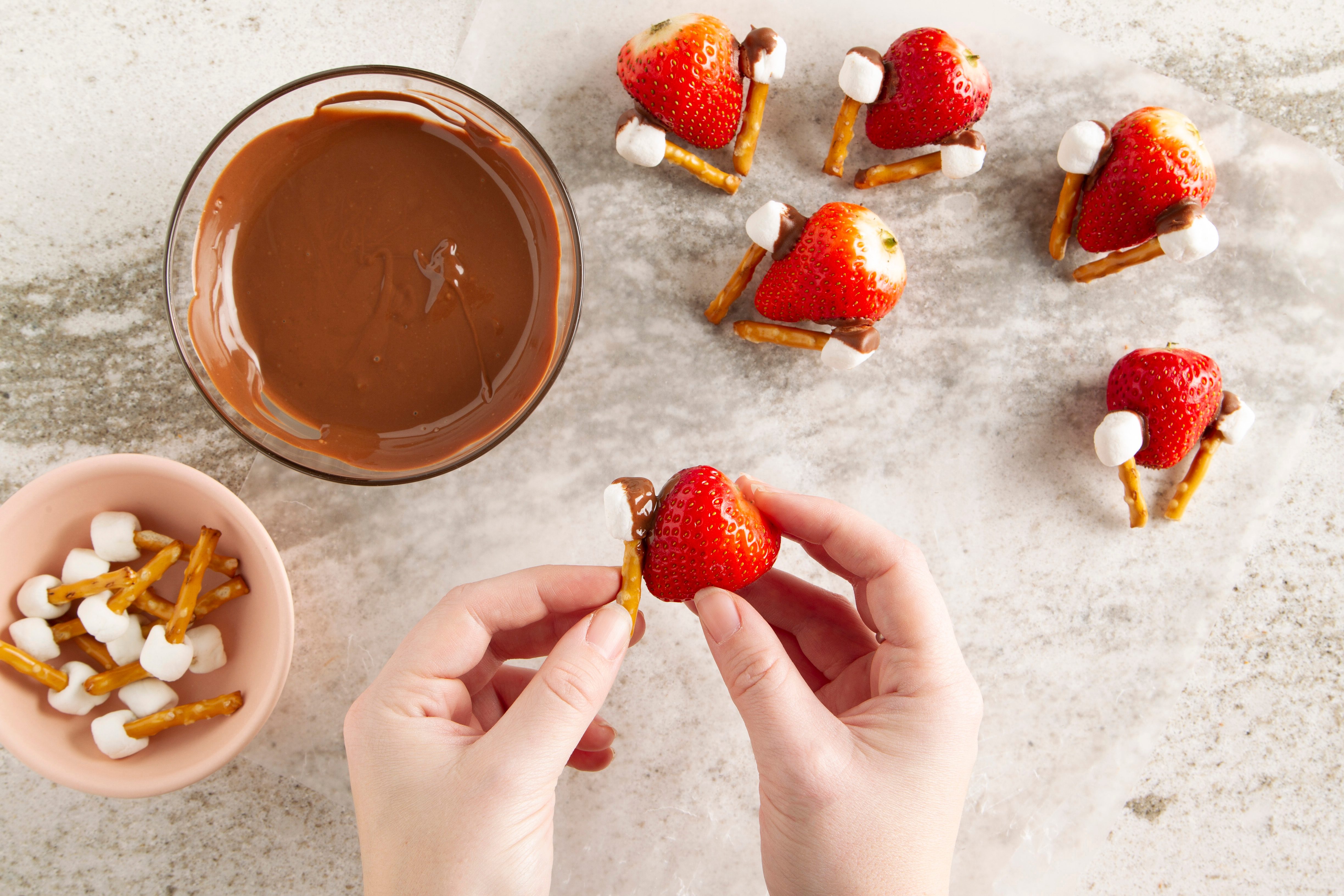 attaching turkey legs to strawberry for chocolate covered strawberry turkeys
