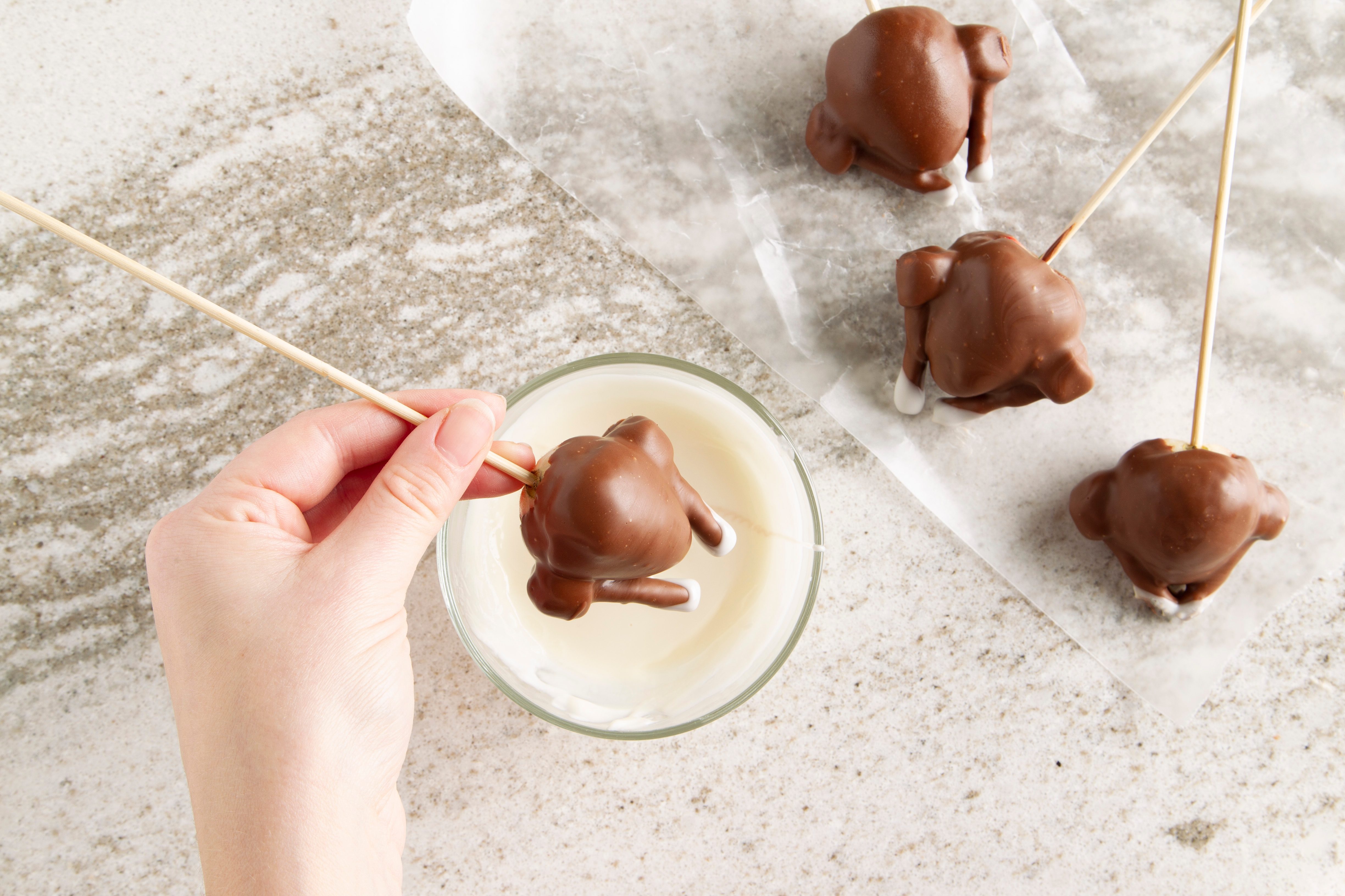 dipping chocolate covered strawberry turkey into white chocolate
