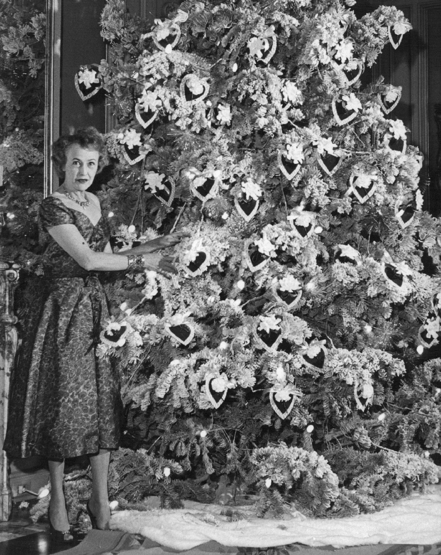 FEB 14 1958, FEB 15 1958; Unique Valentine's Day tree highlighted Miss Eleanore Weckbaugh's Friday night party. The tree is her redecorated Christmas tree and features valentines of gardenias, carnations.;