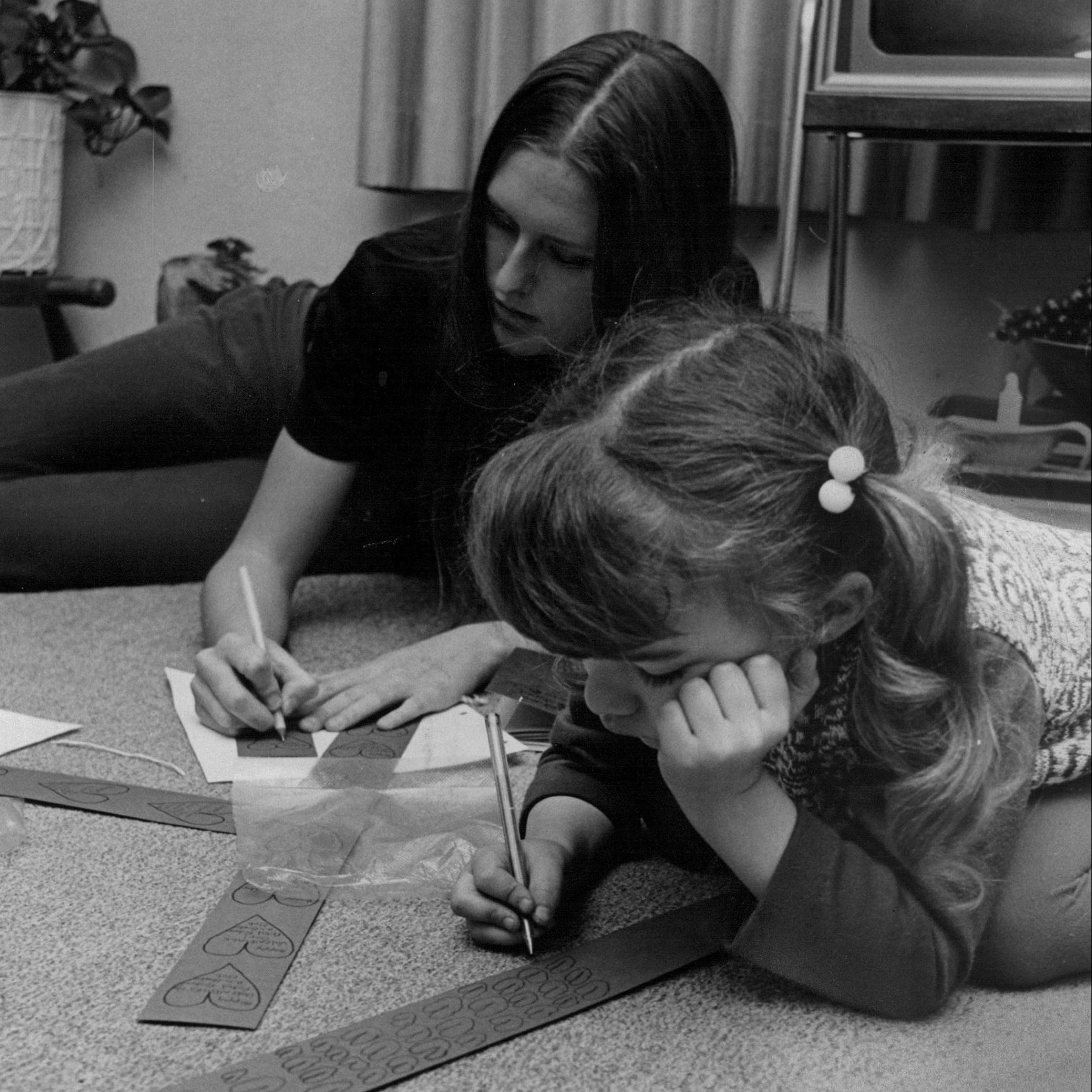 Mary Hayes, Arvada West member of the Petal Pushers Garden Club, and Robin Stover, 5-year-old daughter of club's adviser, Mrs. David Stover, make Valentine tray favors for Colonial Manor Nursing Home residents. 