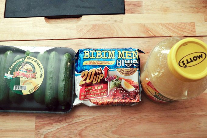 Ramen noodle package with apple sauce and package of cucumbers
