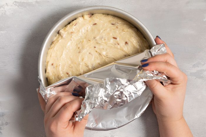 A person Covering the pan with foil