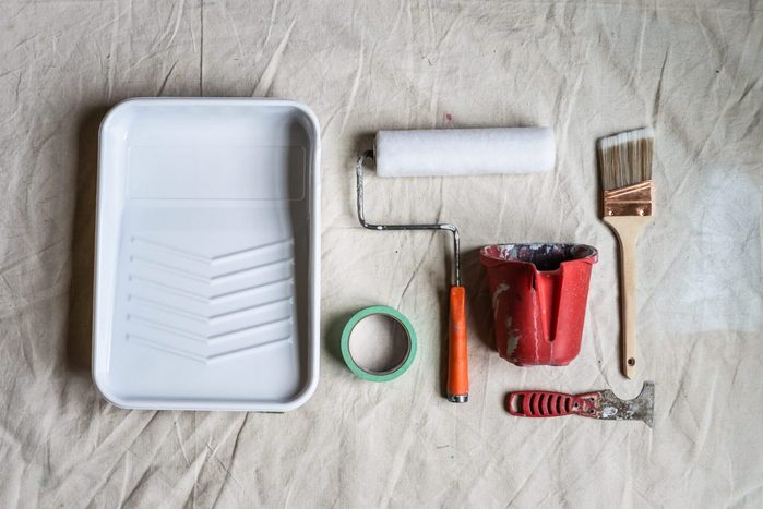 House painting DIY home not a lot of painting tools improvement flat lay brush roller on drop cloth