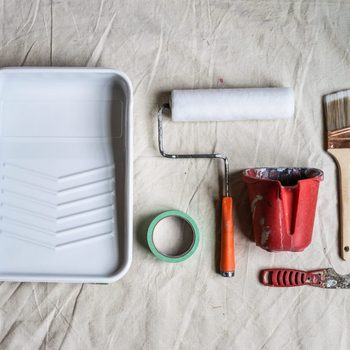 House painting DIY home not a lot of painting tools improvement flat lay brush roller on drop cloth