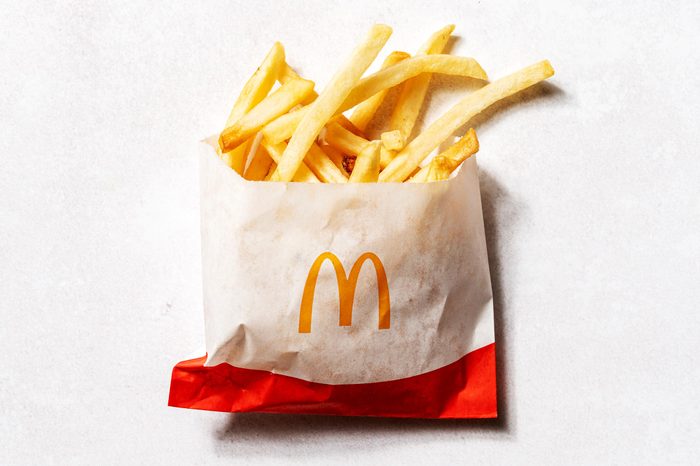 KFC fries in a cardboard cup that says kentucky fried chicken secret recipe fries