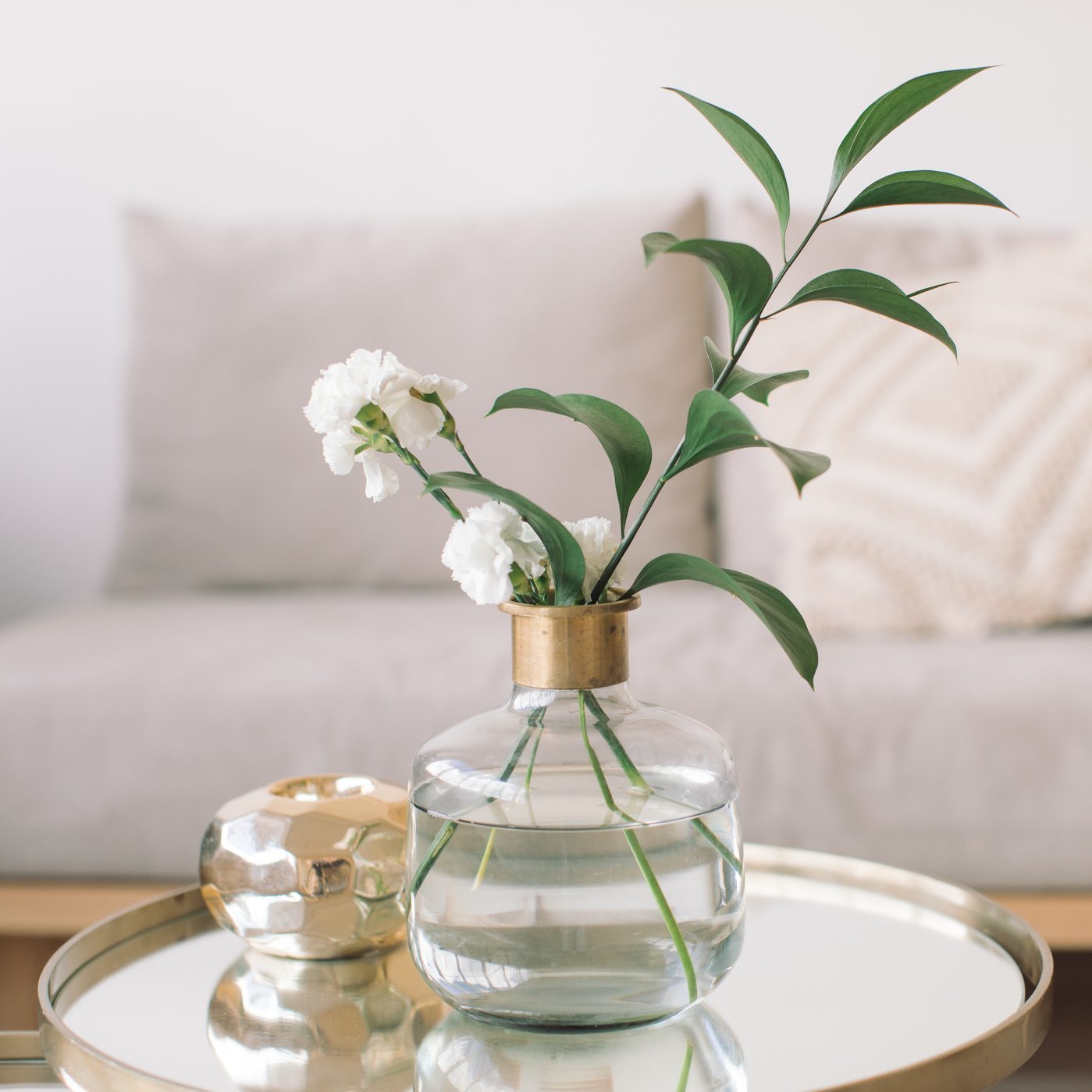 flowers in bud vase on side table