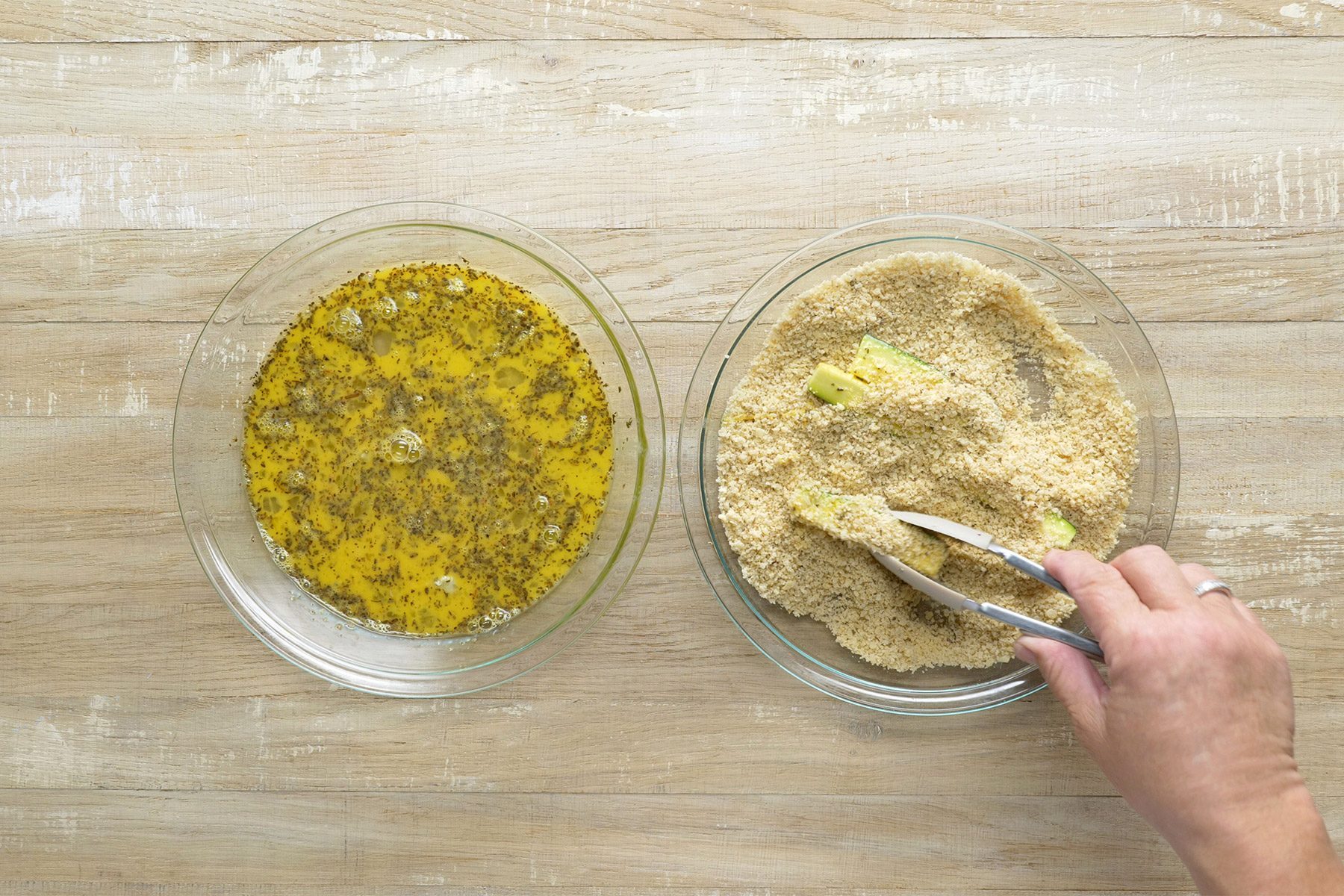 overhead shot of zucchini slices dipped in crumb mixture