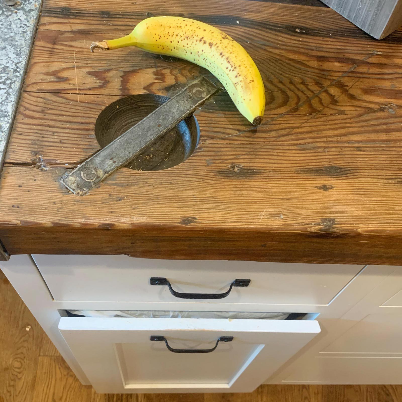 If You See a Wooden Table with a Circular Metal Indent, It’s Probably a Hatch Door Table