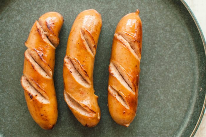 High angle view of bratwurst sausages on a rustic plate