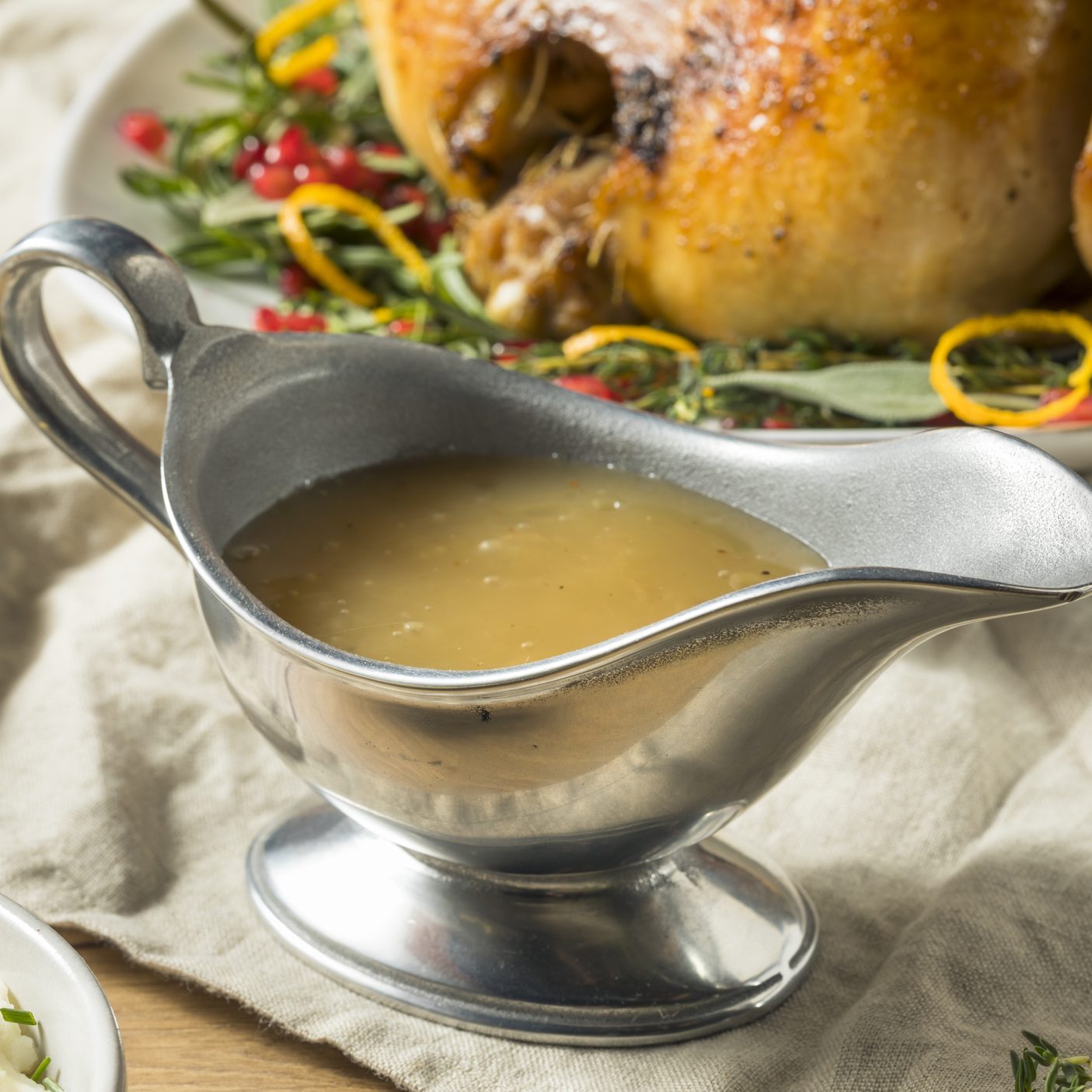 Dark Homemade Turkey Gravy in metal gravy boat