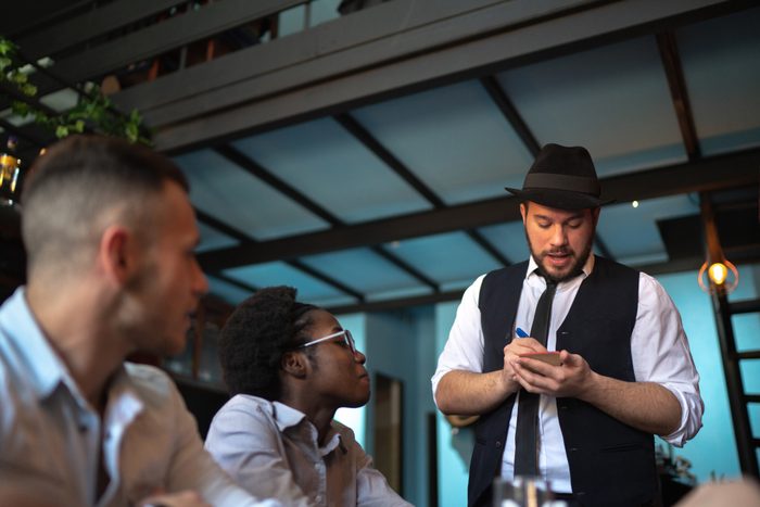 Waiter taking client's order