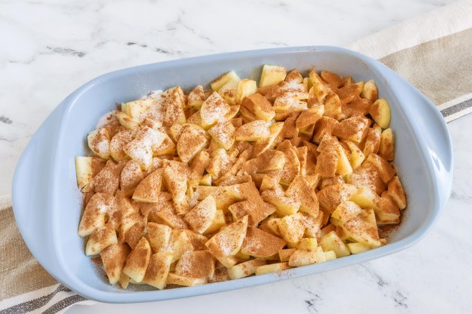 a blue baking dish with cinnamon apples for Amish 'apple Goodie