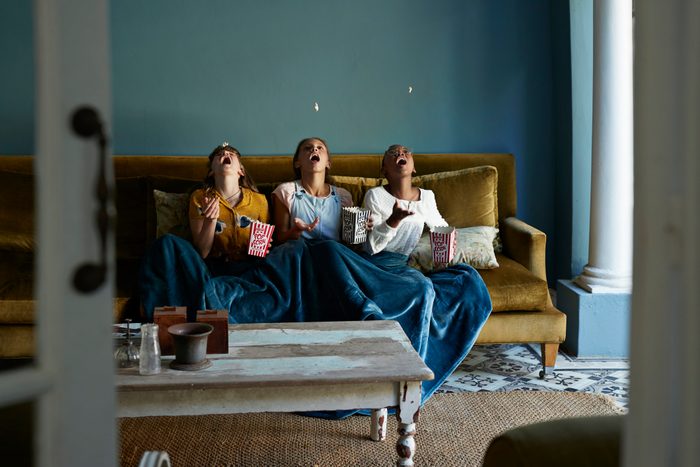 3 friends catching popcorn with the mouth