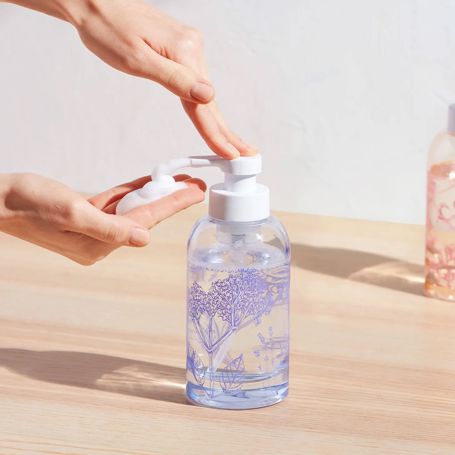 hand using foaming blue land soap