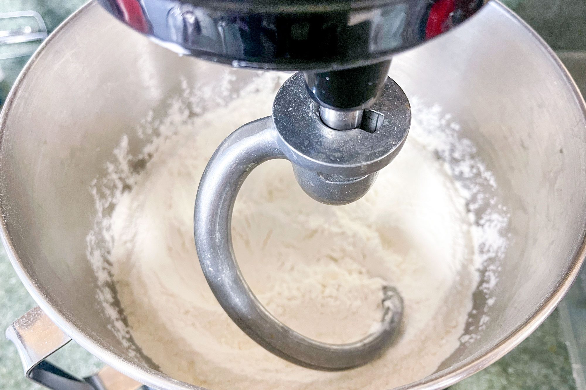 close up of dough hook attachment in a mixer