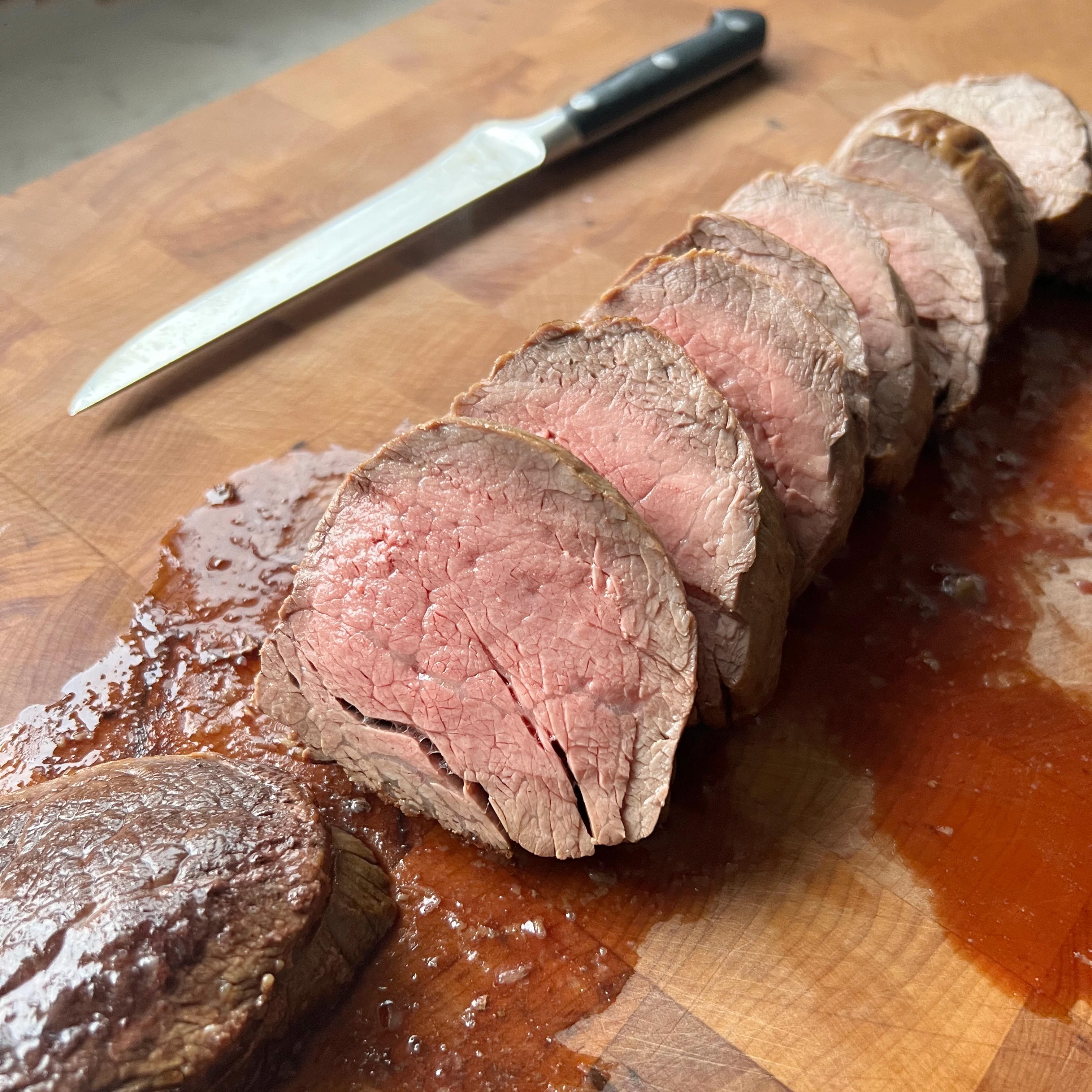 Ina Garten's Beef Tenderloin cut up on a cutting board