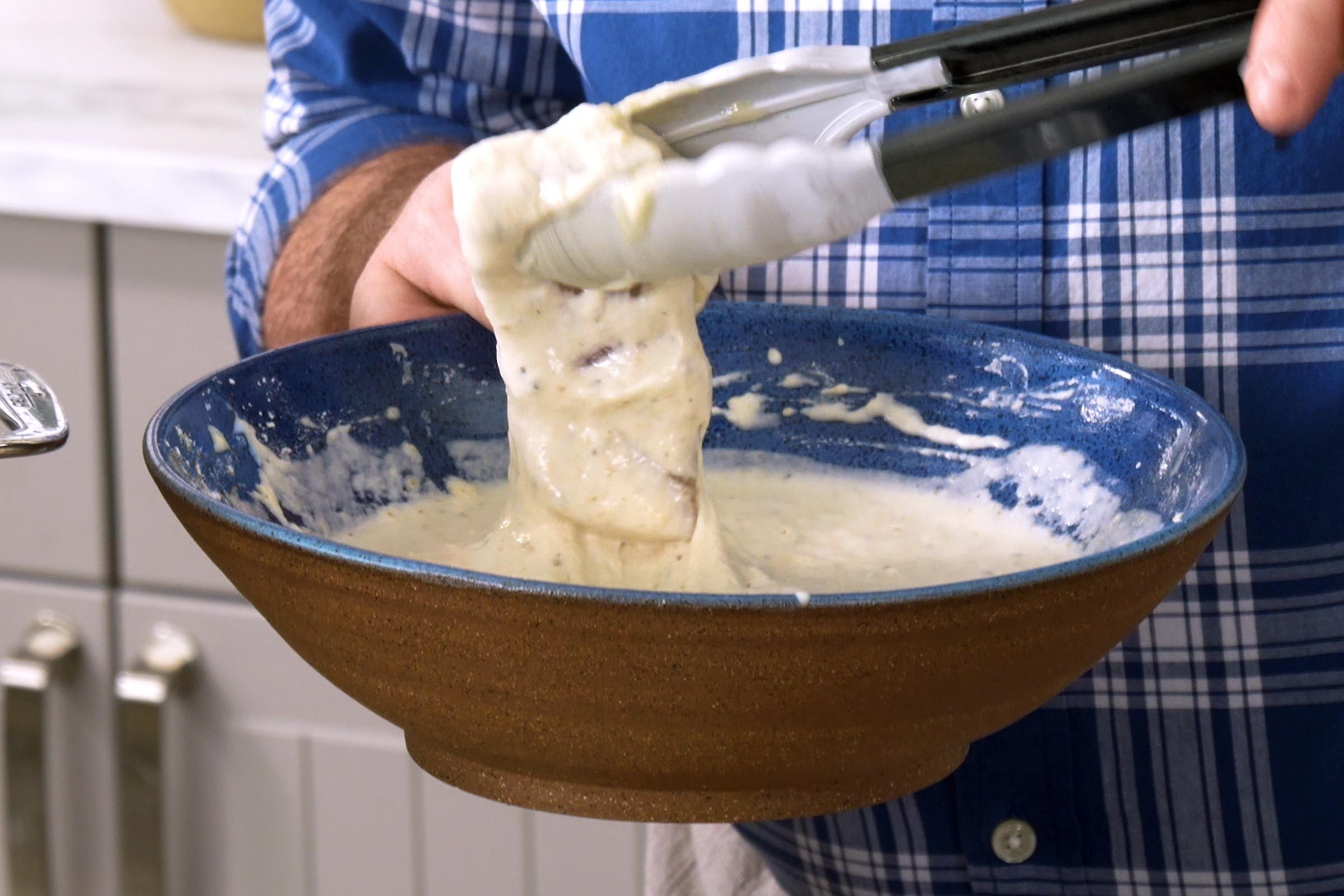 coating fish in batter before frying