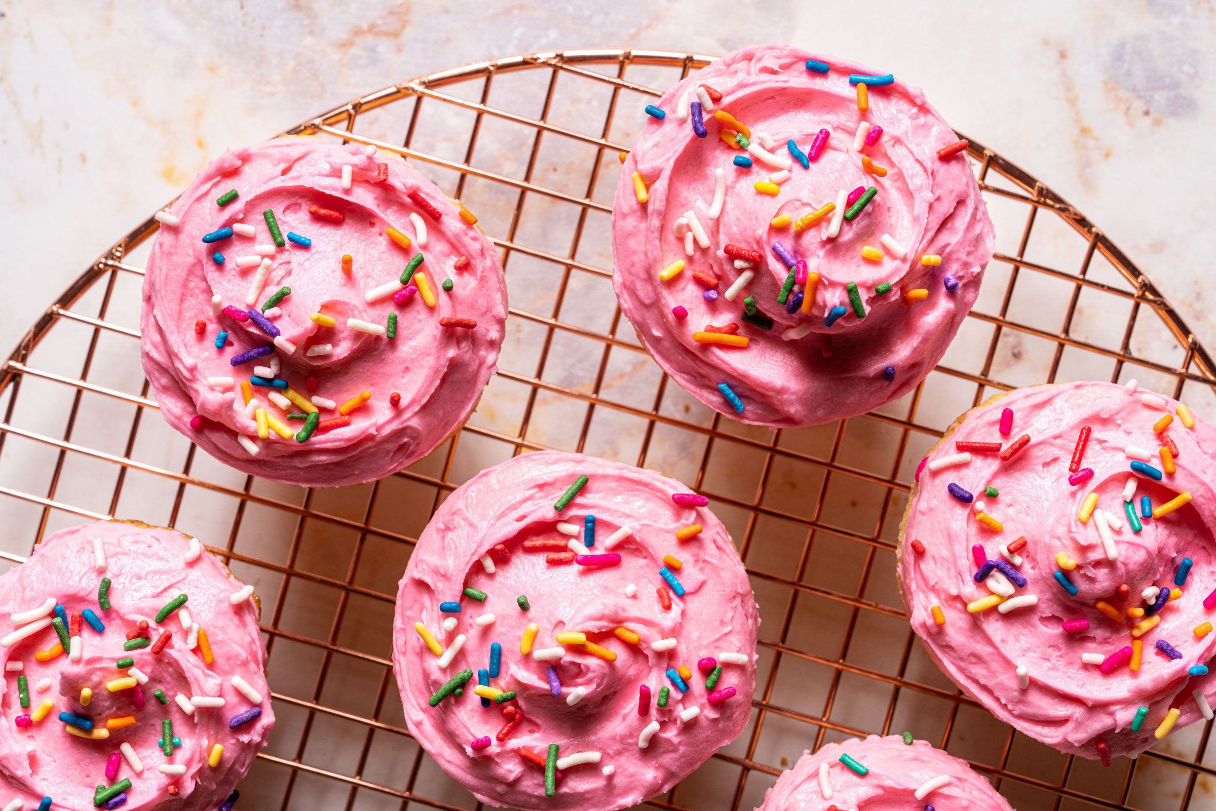 top view of pink frosted cupcakes with sprinkles