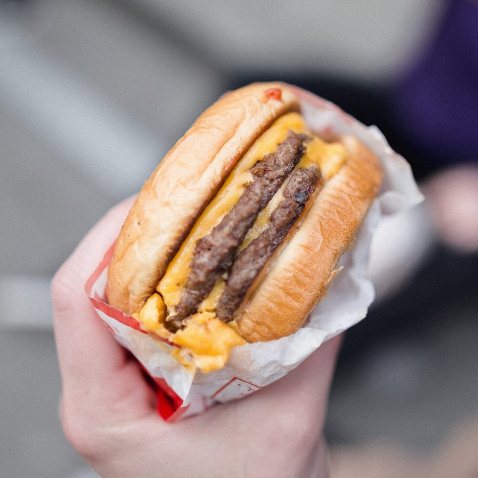 Cropped hand of person holding burger,San Francisco,California,United States,USA