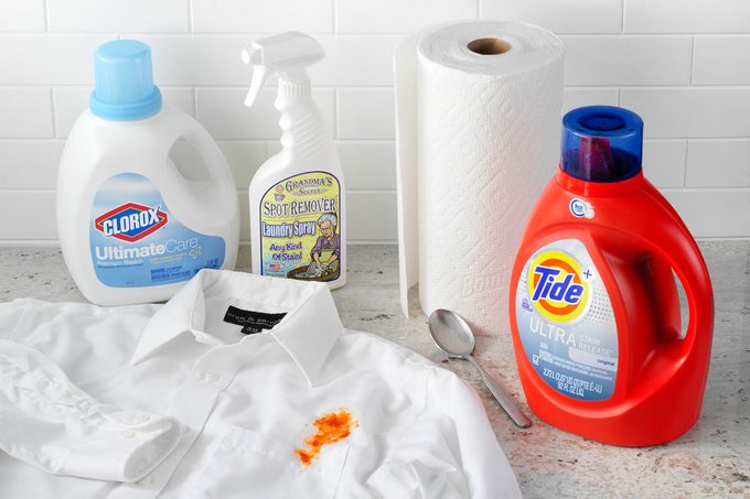 Tomato Sauce stained shirt arranged with cleaning supplies