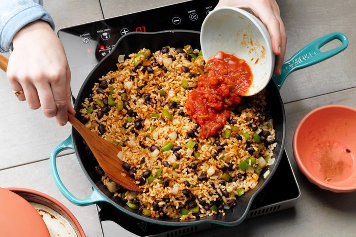 mixing together the burrito filling