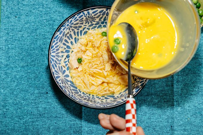 mixing cat cake ingredients in a bowl