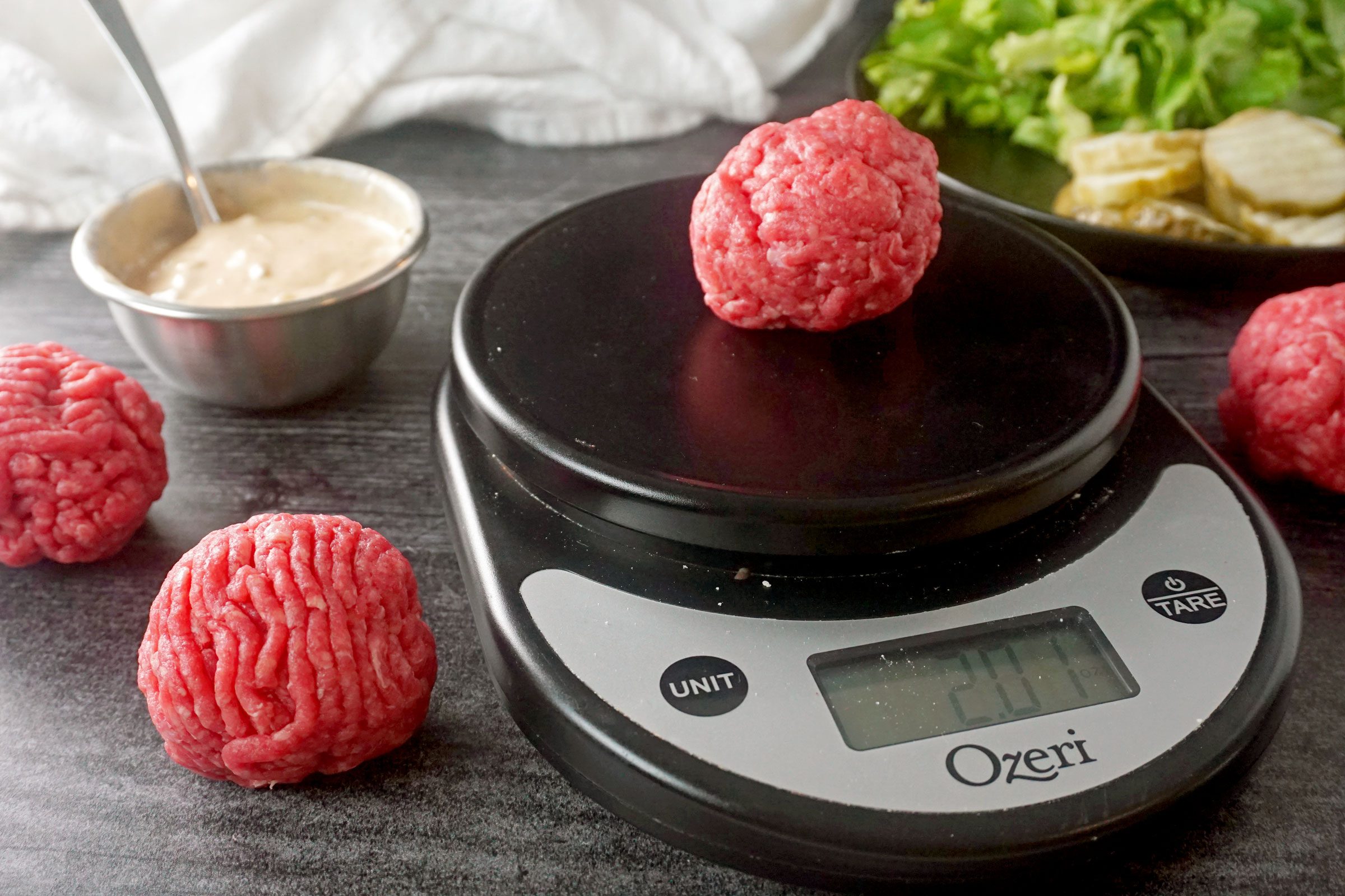 weighing meat balls for smash burgers