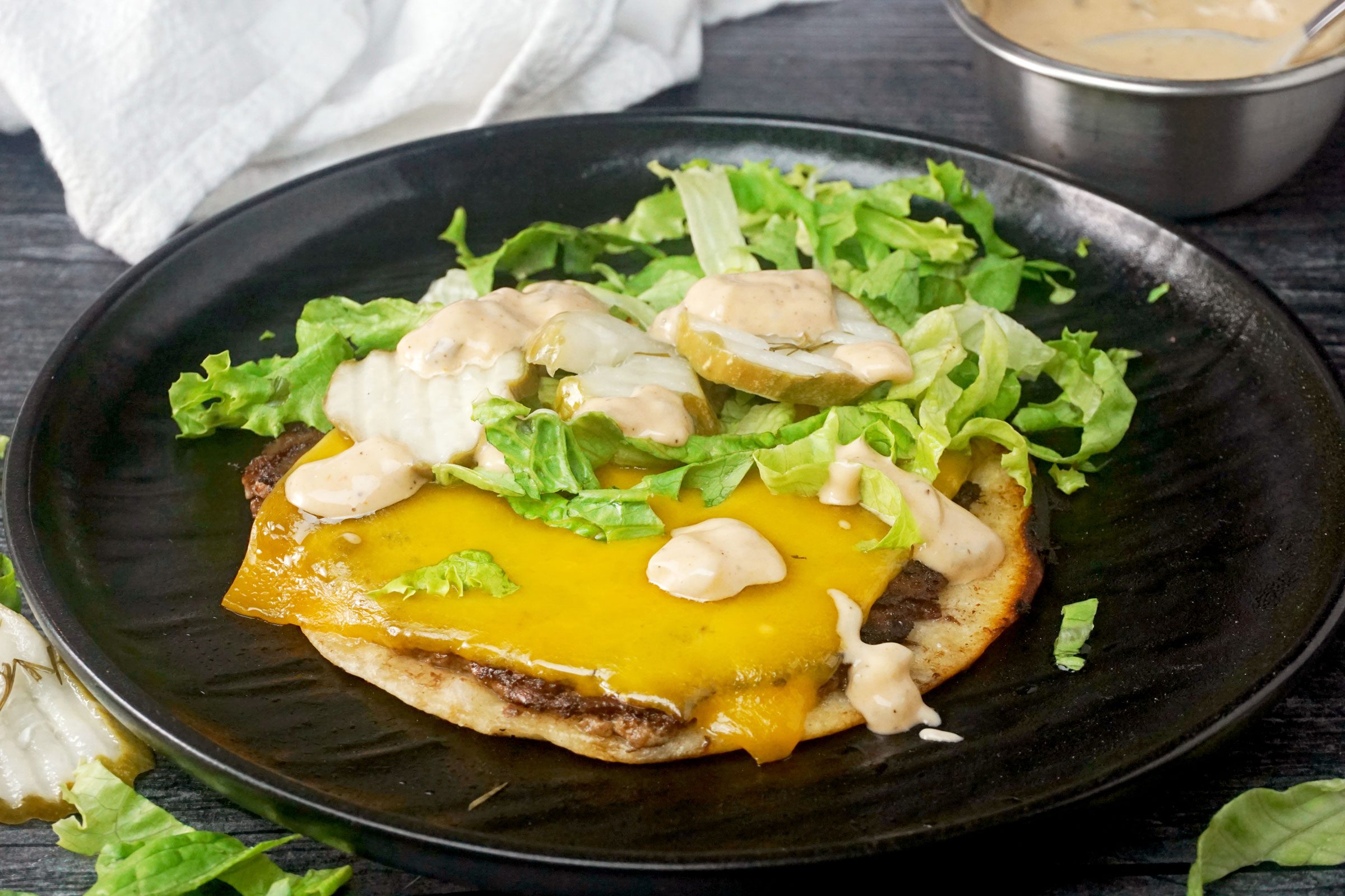 Smash Burger Tacos with toppings on a plate