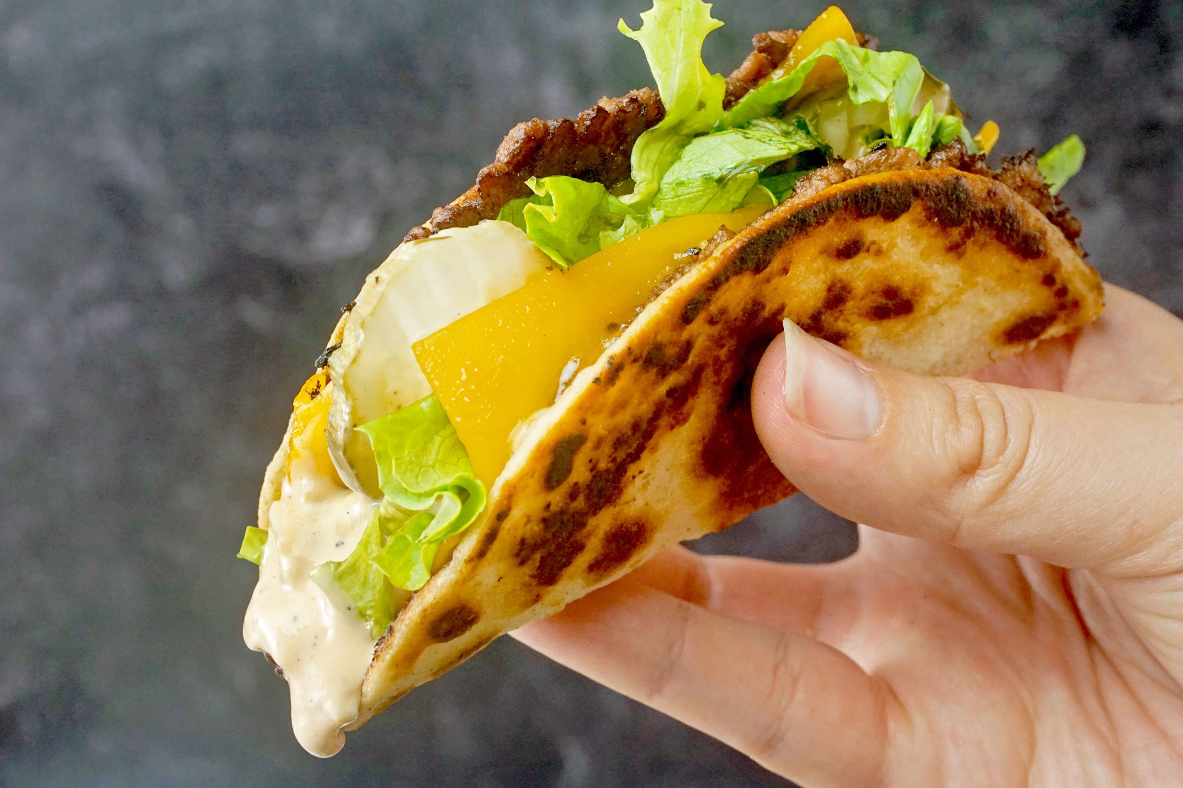 Smash Burger Tacos in a hand