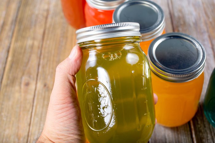 hand holds mason jar with pickle juice