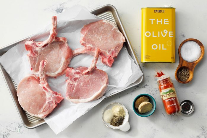 Overhead Shot Of All Ingredients For Baked Pork Chops On Marble Surface