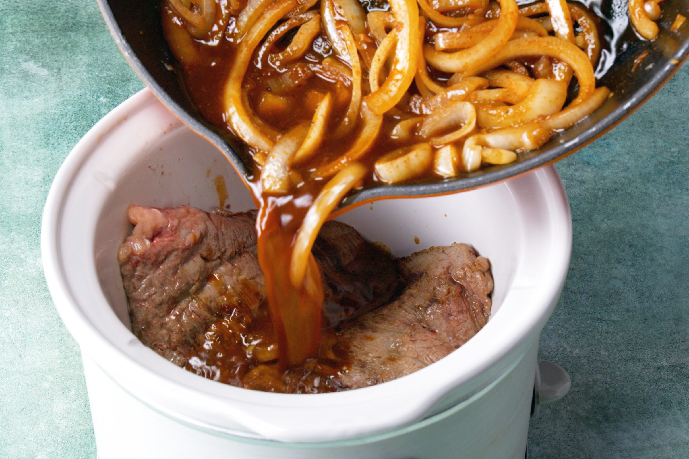 adding ingredients to the slow cooker
