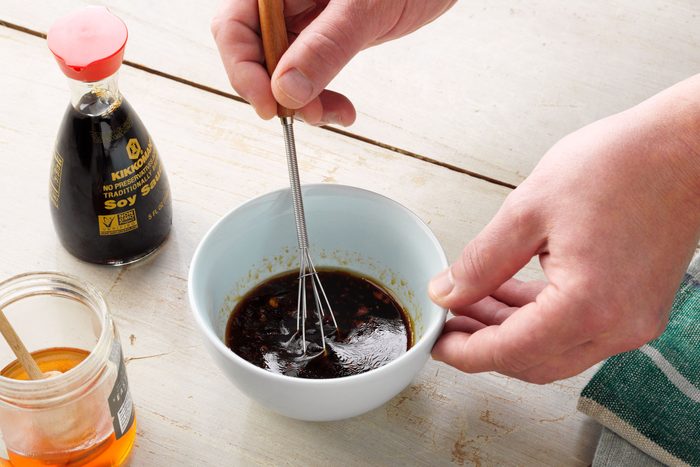 A Person Mixing Sauce in a Bowl