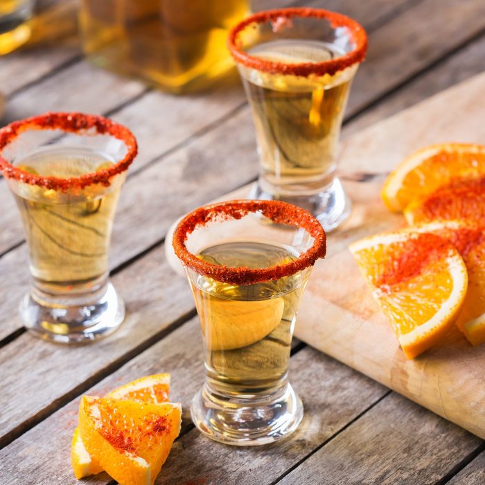 Mexican mezcal or mescal shot with chili pepper and orange