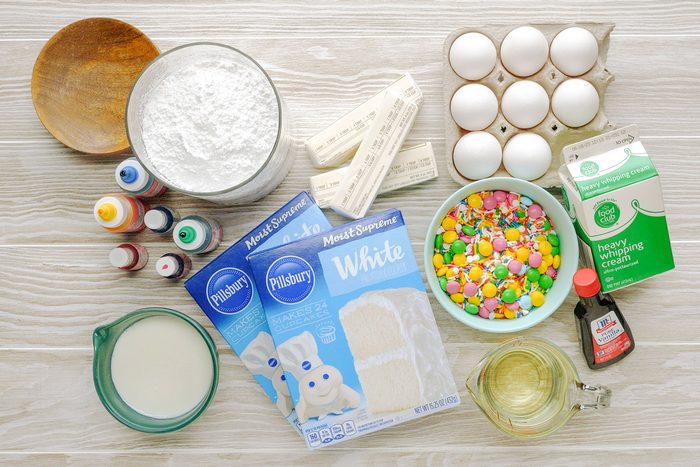 Ingredients Of Surprise Cake spread out on wood surface