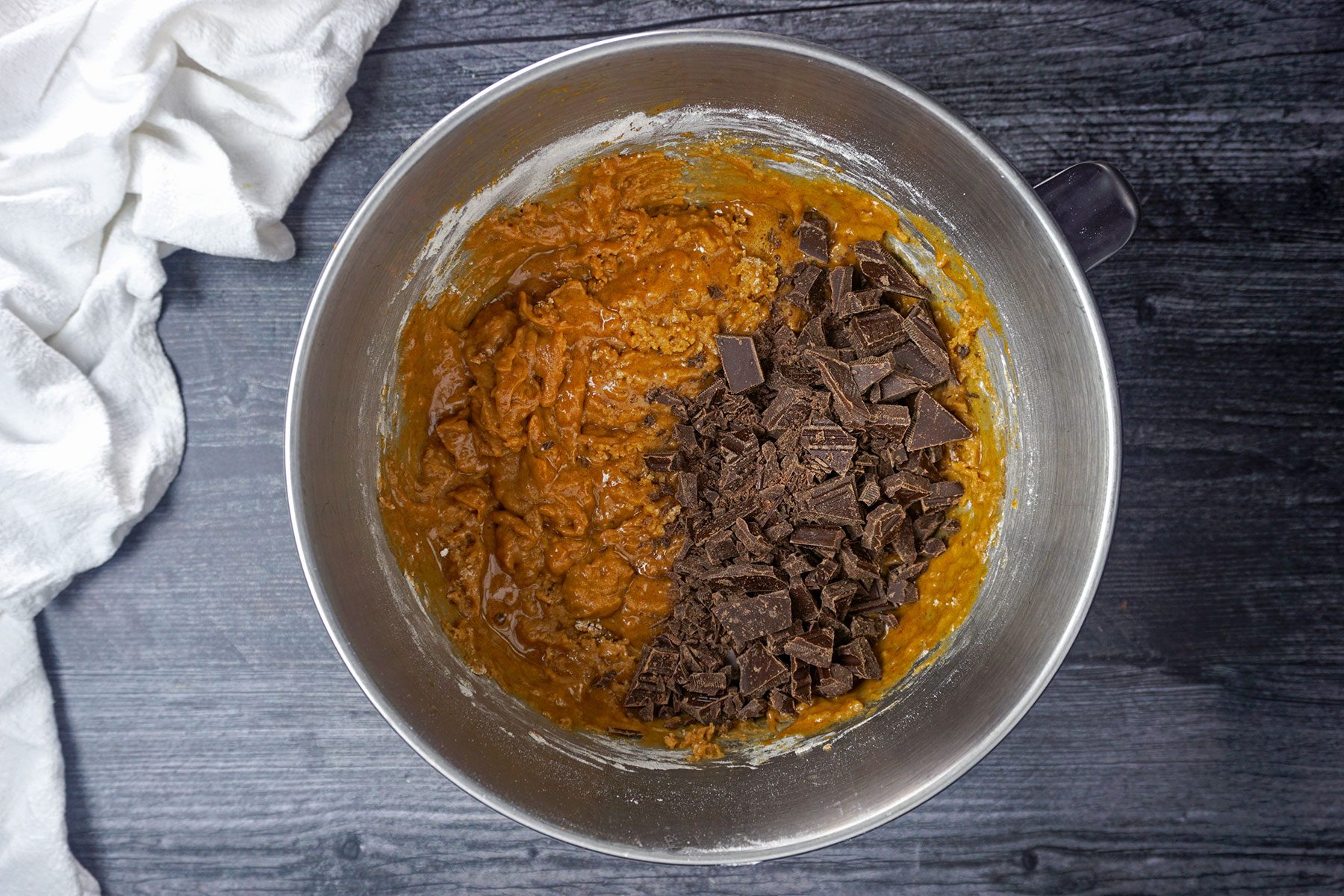 Mixing chocolate chunks in pumpkin smores cookie dough