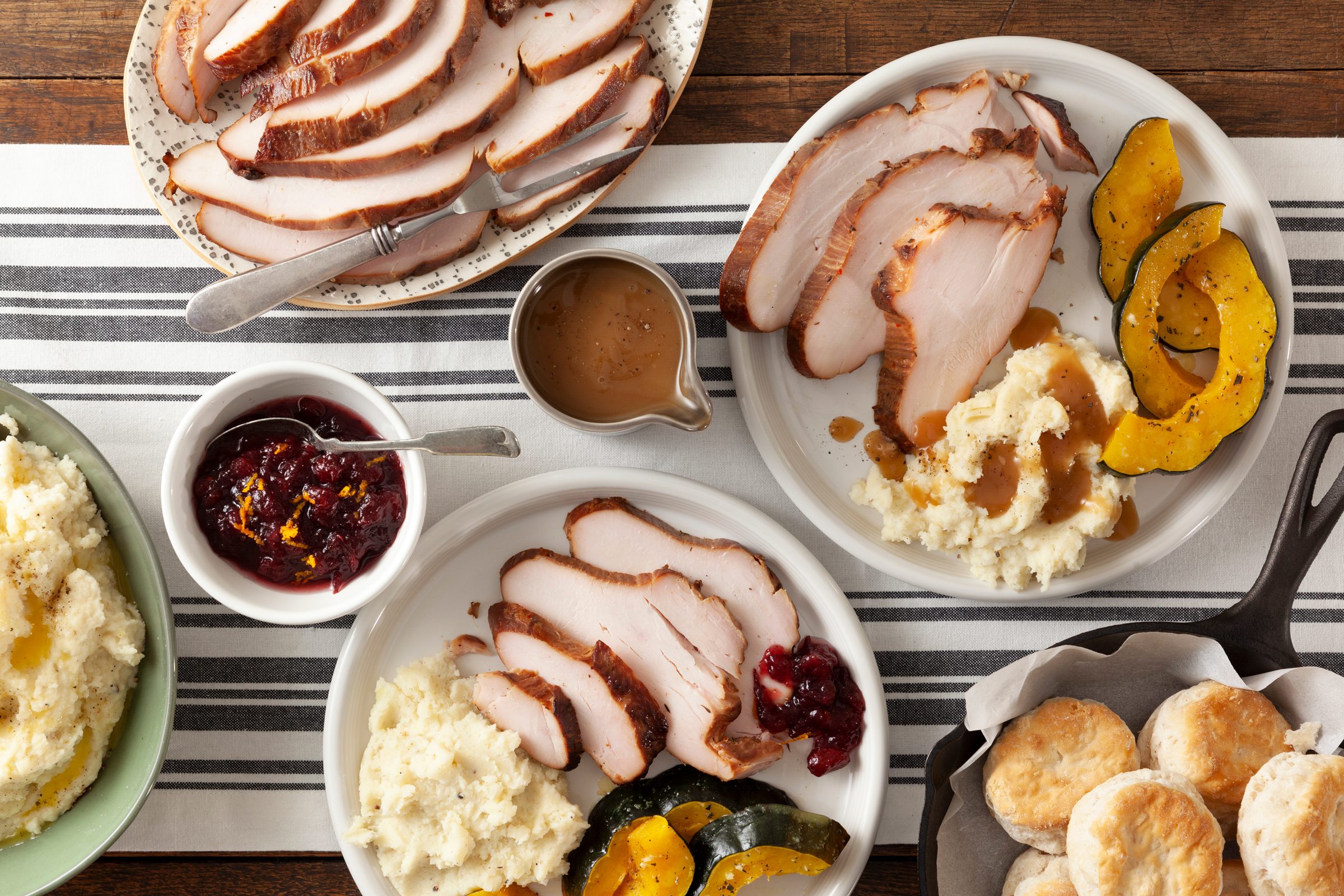 Brined Grilled Turkey Breast sliced on two plates with sides