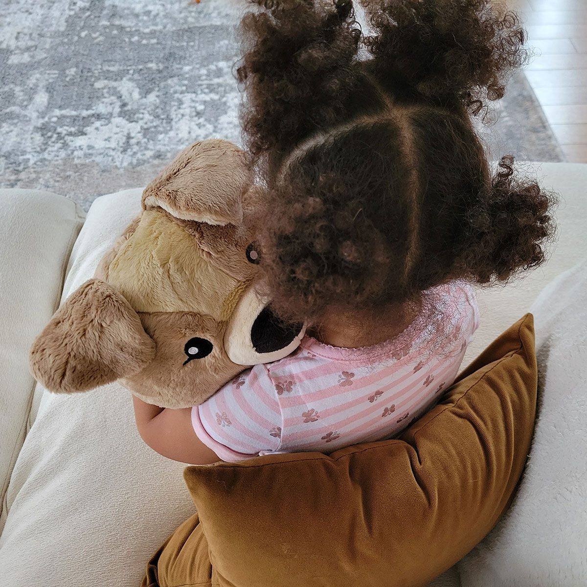 Girl holding stuffed animal