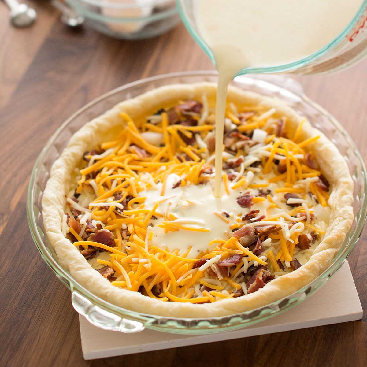 Pouring the liquid ingredients in dough