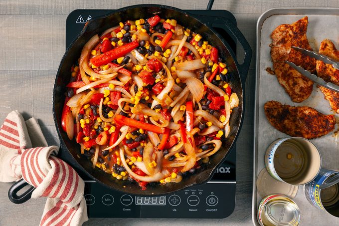 Vegetables being sauted in a large skillet