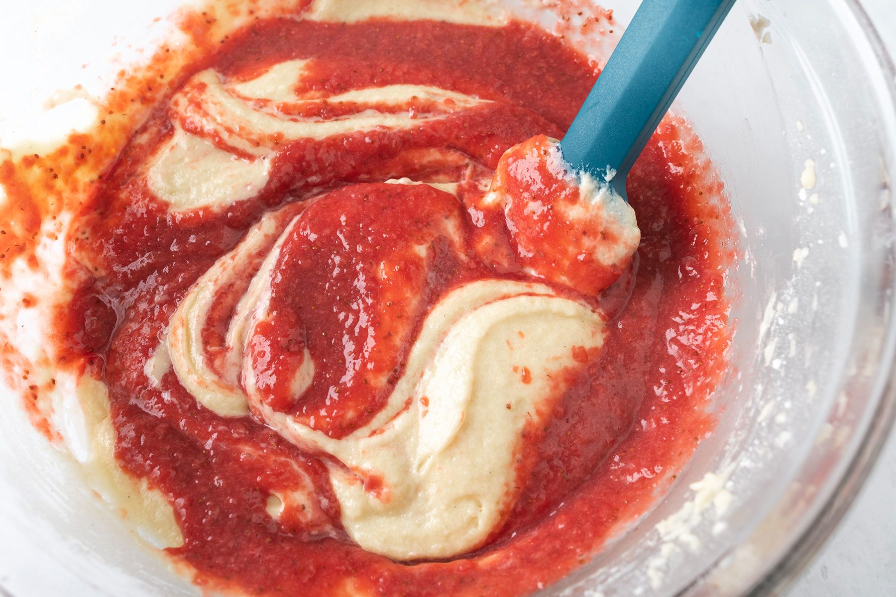 Folding Strawberry Puree in a large bowl
