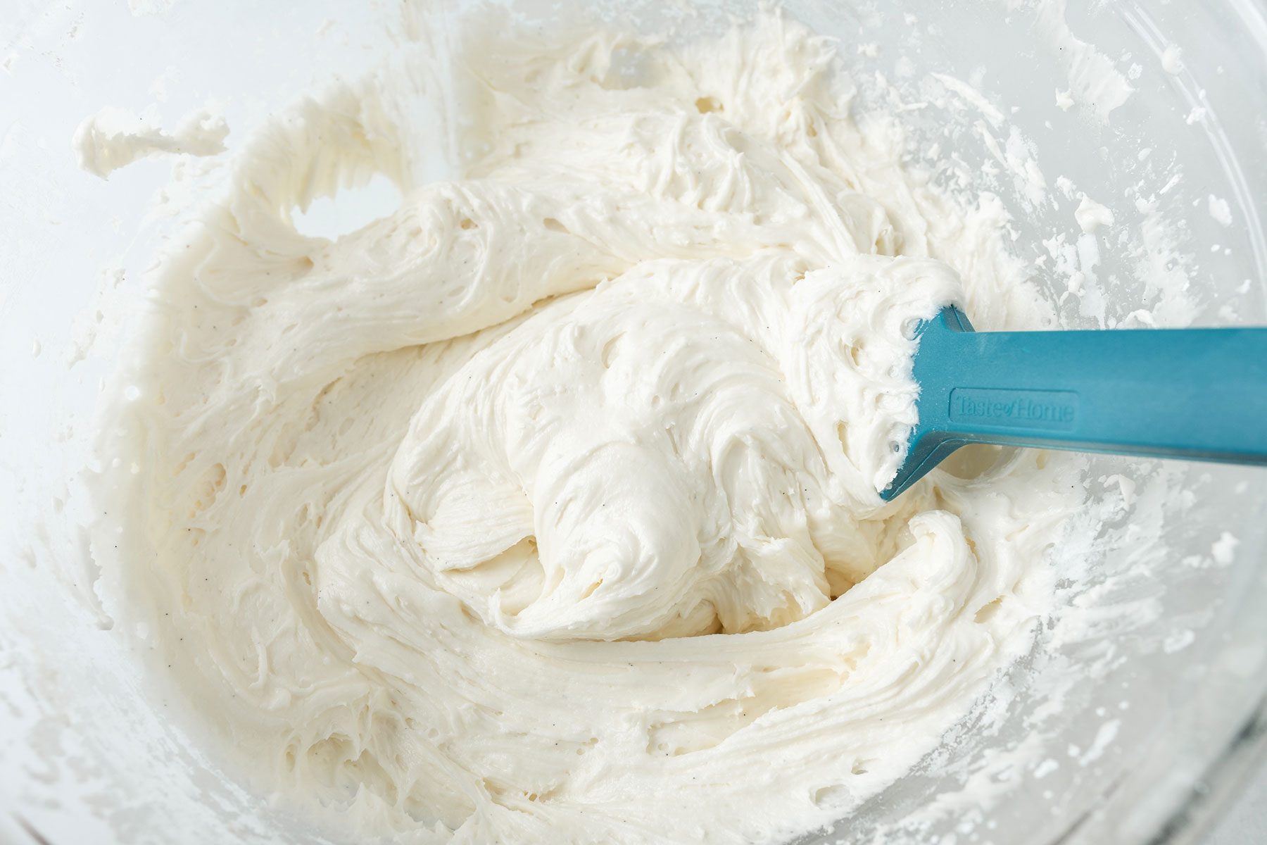 folding the frosting in a large bowl