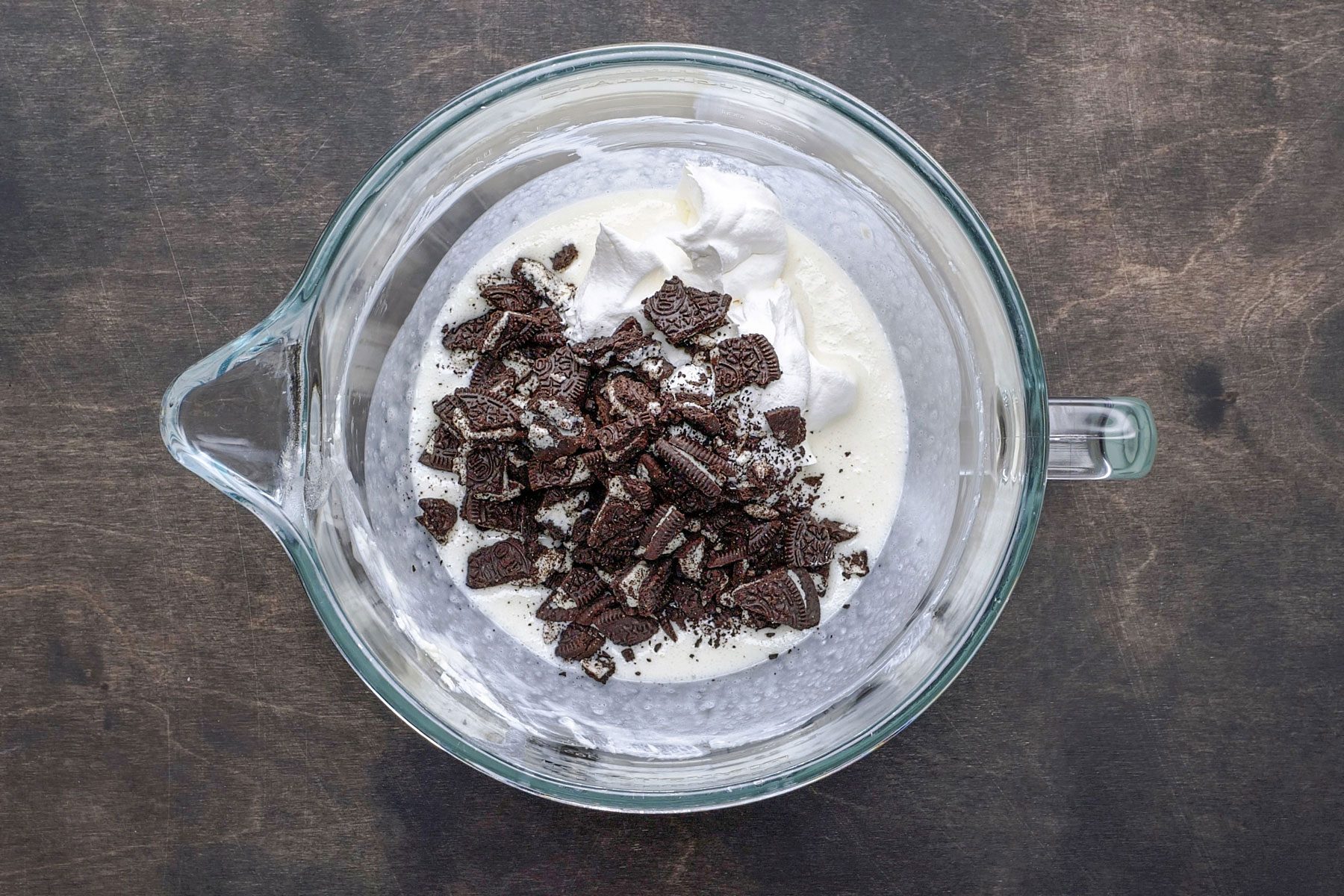 Chopped cookies and cream cheese in a bowl