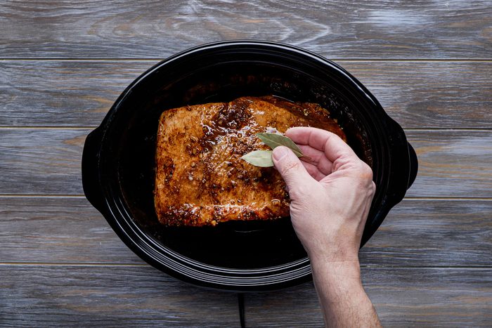 Slow cook the brisket with broth and bay leaves
