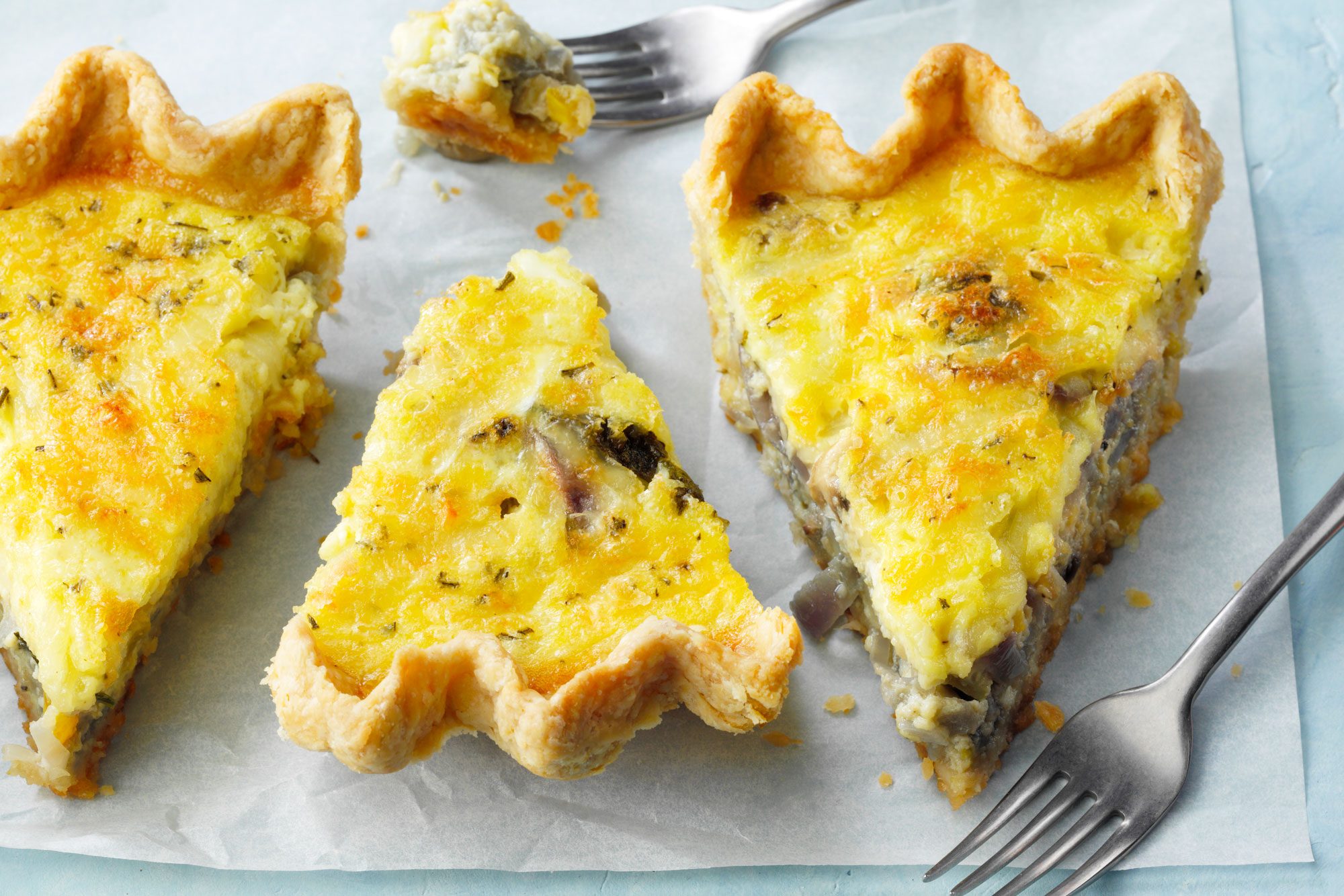 Sliced Vegetable Quiche served in a tray with fork