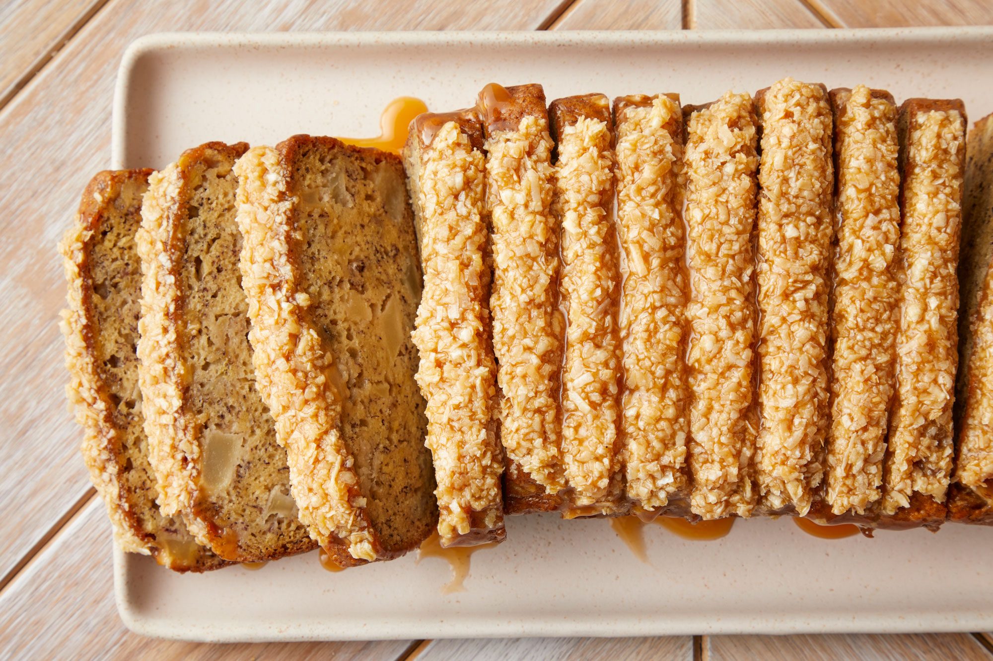 A plate of sliced Apple Banana Bread served with coconut glazed topping