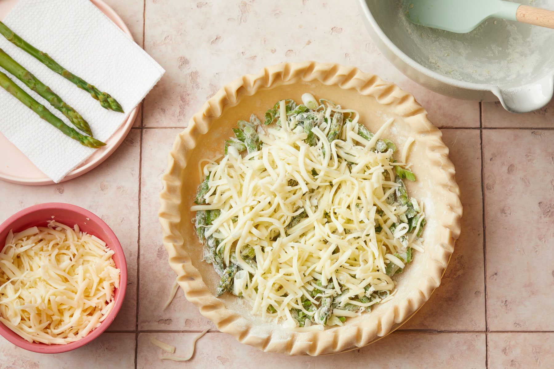 Cheese on Asparagus pie crust on a kitchen countertop