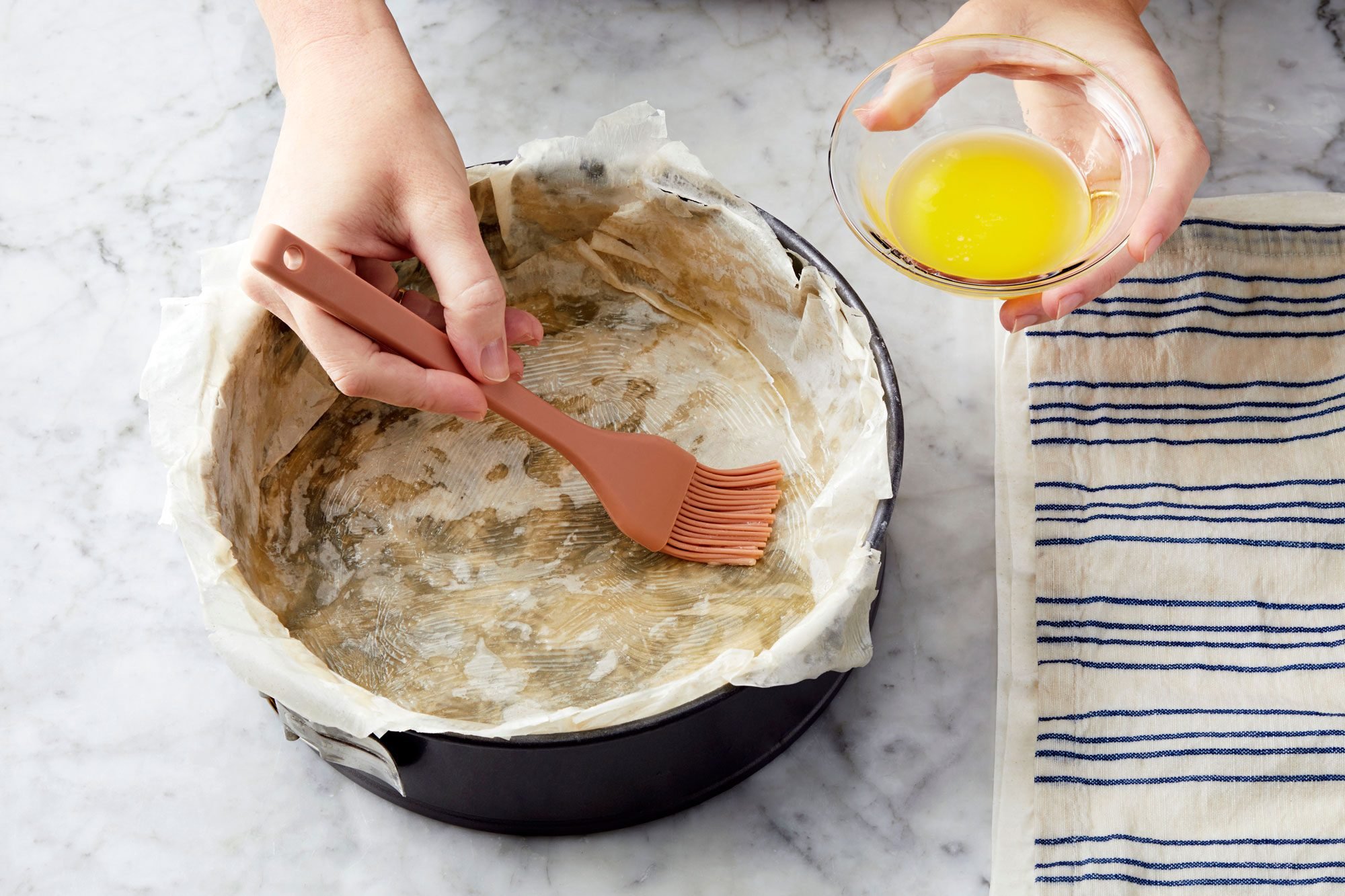 Brush the phyllo with butter in a springform pan